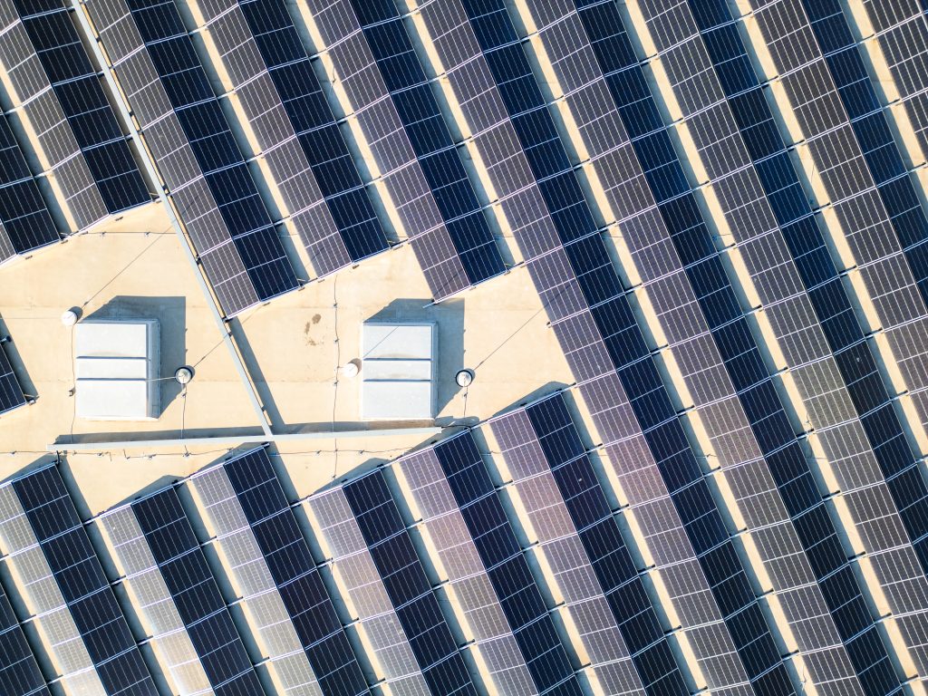 Close-up aerial view of rooftop solar panels generating clean energy.