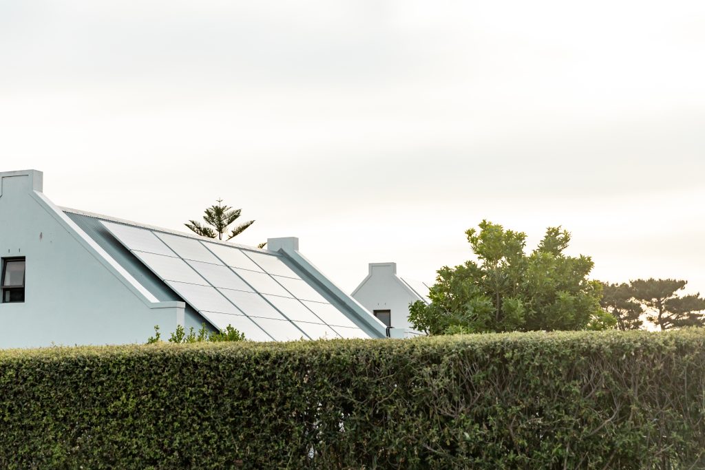 Modern home with solar panels installed on the roof, promoting residential renewable energy.